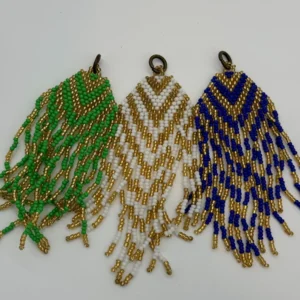Three different colored beads hanging on a white wall.