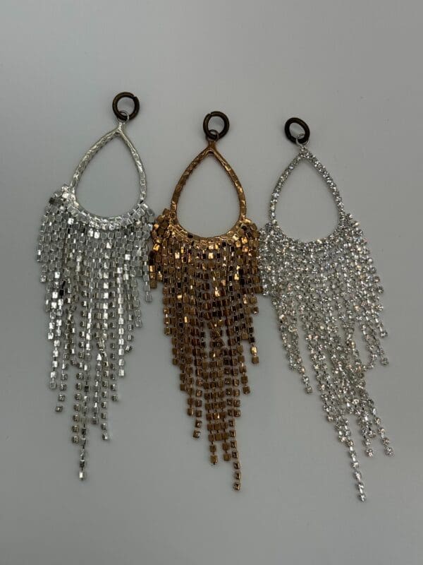 A group of three earrings hanging from chains.