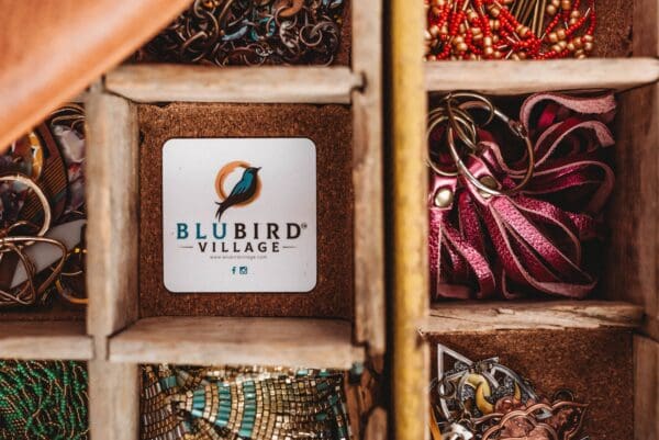 A wooden box filled with various jewelry items.