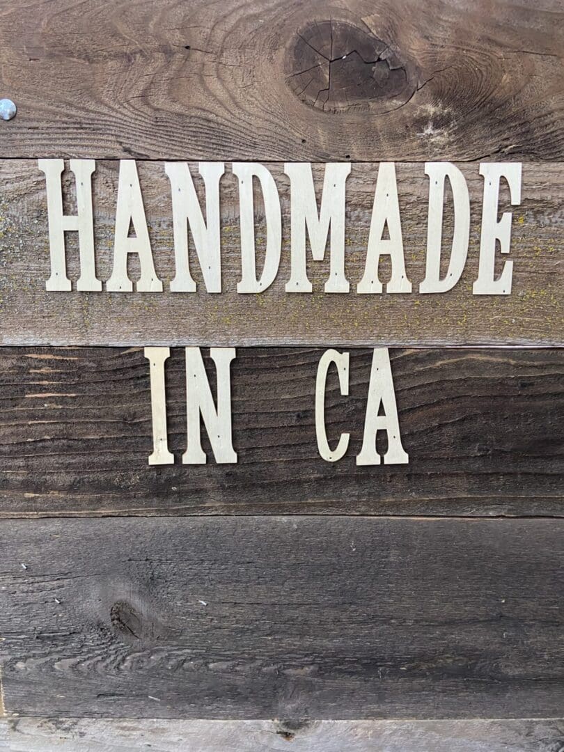 A sign that says handmade in ca on the side of a building.