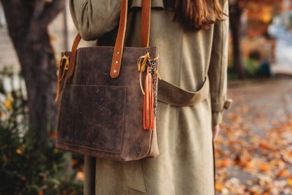 A woman holding onto a brown bag