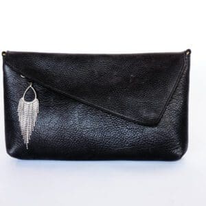 A black purse with a feather on it