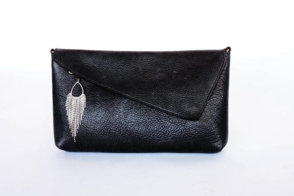 A black purse with a feather on it