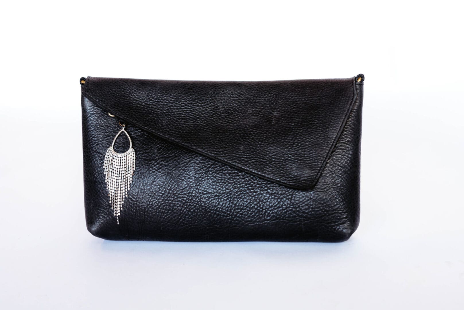 A black purse with a feather on it