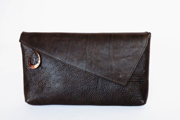 A brown purse with a wooden handle on the side.