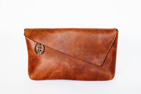 A brown leather purse with a button on the front.