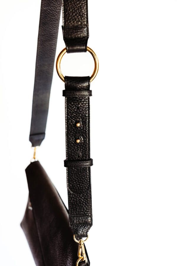 A black leather strap hanging on the wall.