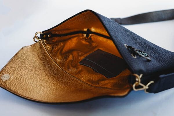 A purse that has a small compartment in it.