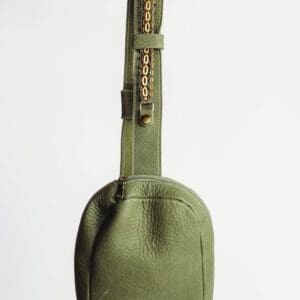 A green bag with a strap on it