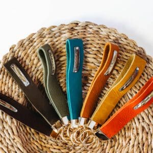 A basket with several different colored handles on it.