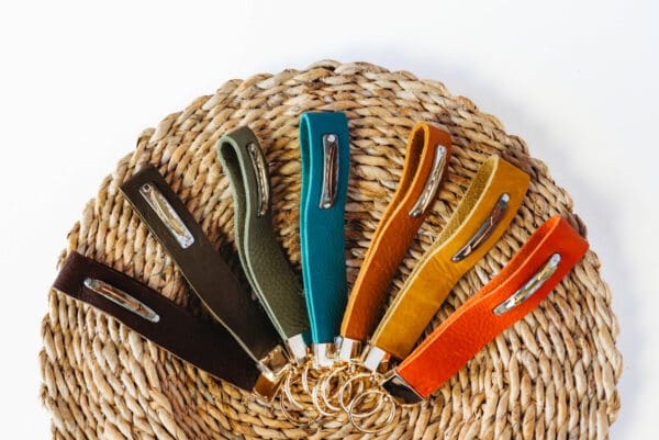 A basket with several different colored handles on it.