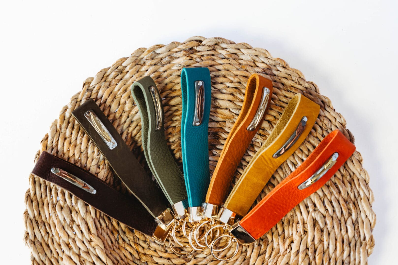 A basket with several different colored handles on it.