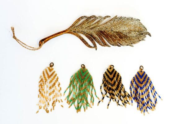 A feather and four different colored feathers