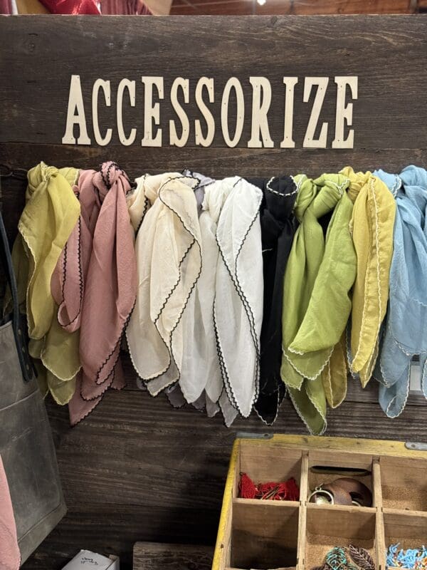 A wall with many different colored towels hanging on it.