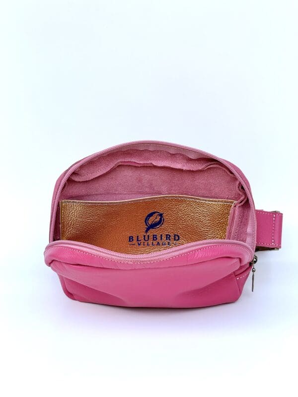 A pink purse with a small pocket inside of it.