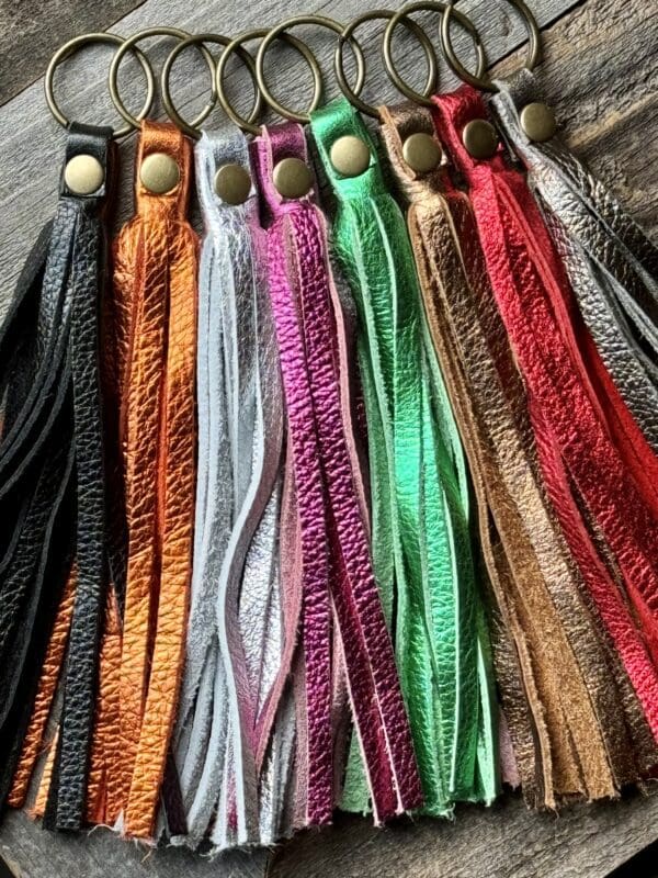 A bunch of different colored tassels are hanging up