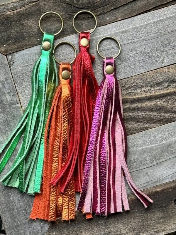 A group of three different colored tassels on top of each other.