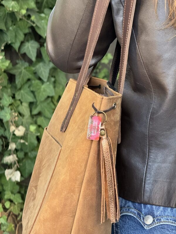 A person holding onto a brown bag