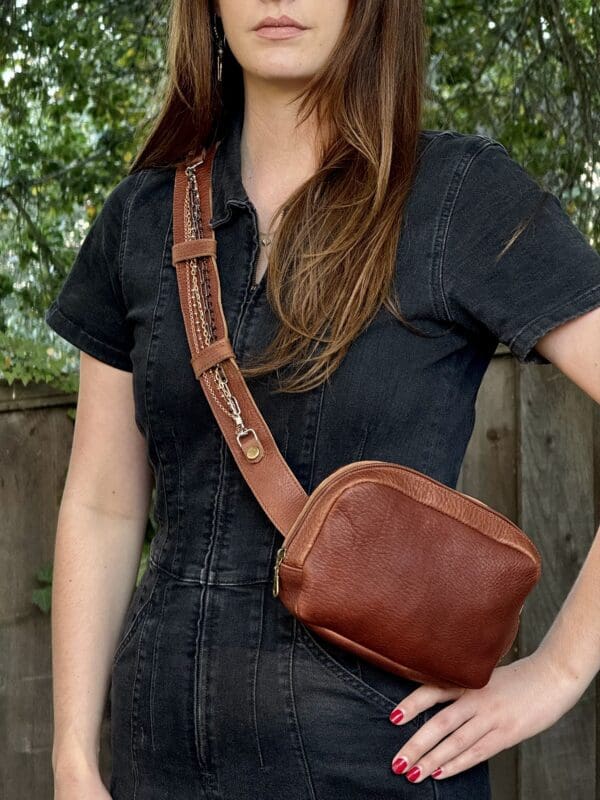 A woman wearing a black shirt and brown purse.