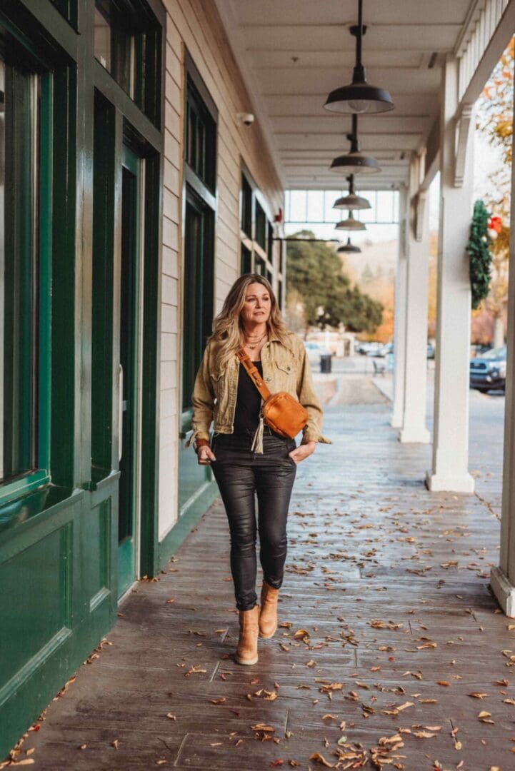 A woman is walking down the street in her outfit.