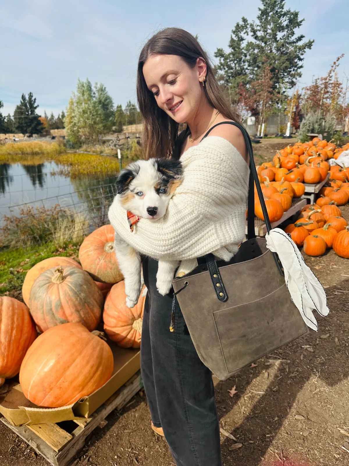 A woman holding her dog in her arms.